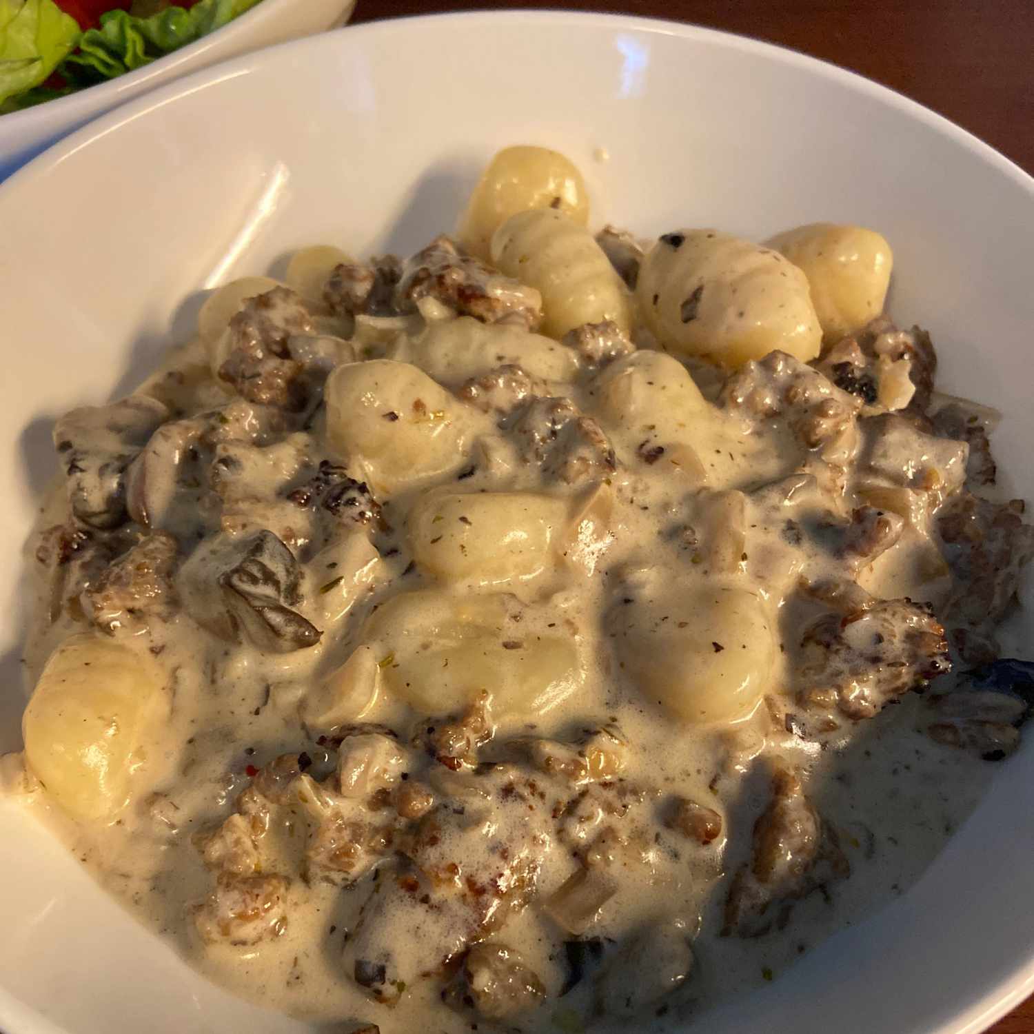 Creamy Sausage and Mushroom Gnocchi Skillet in a white bowl
