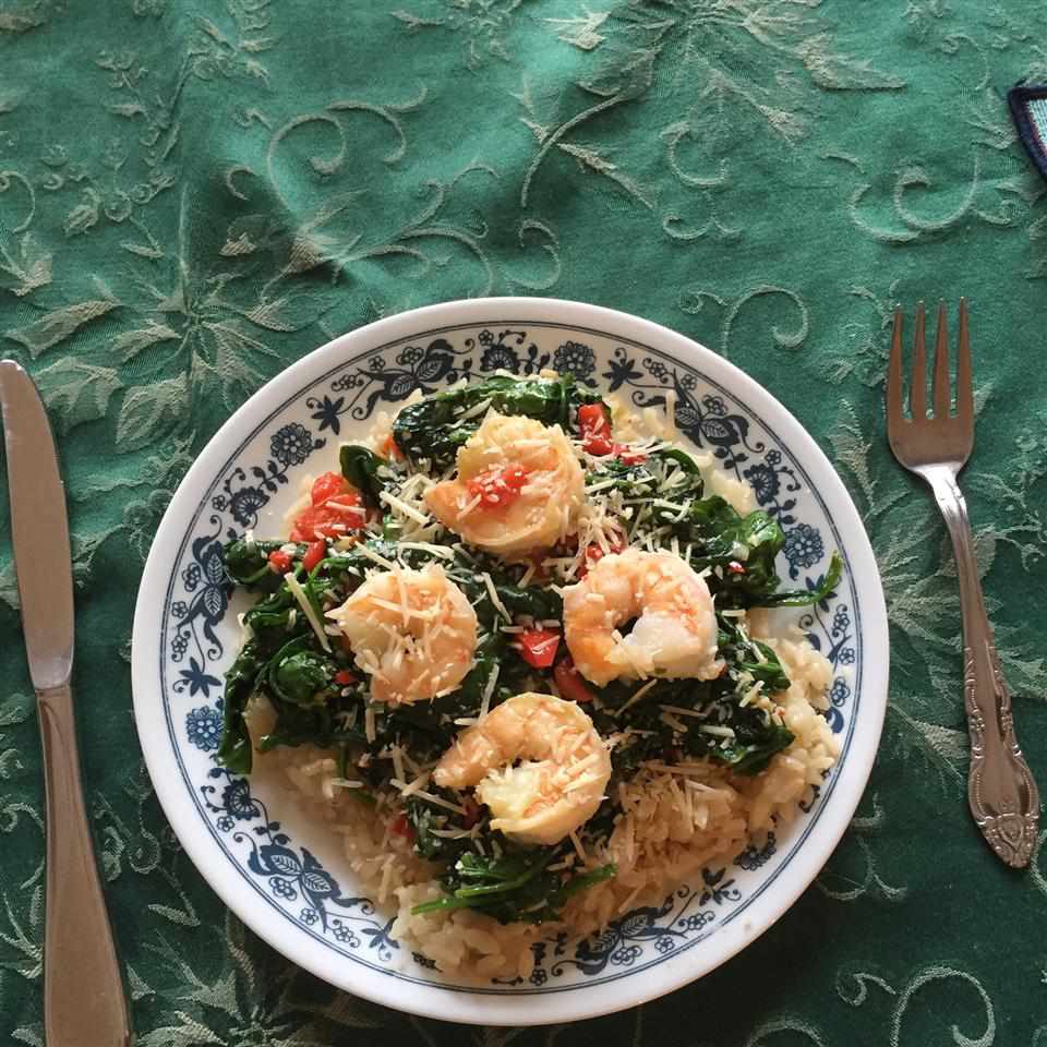 shrimp with risotto and spinach in china bowl