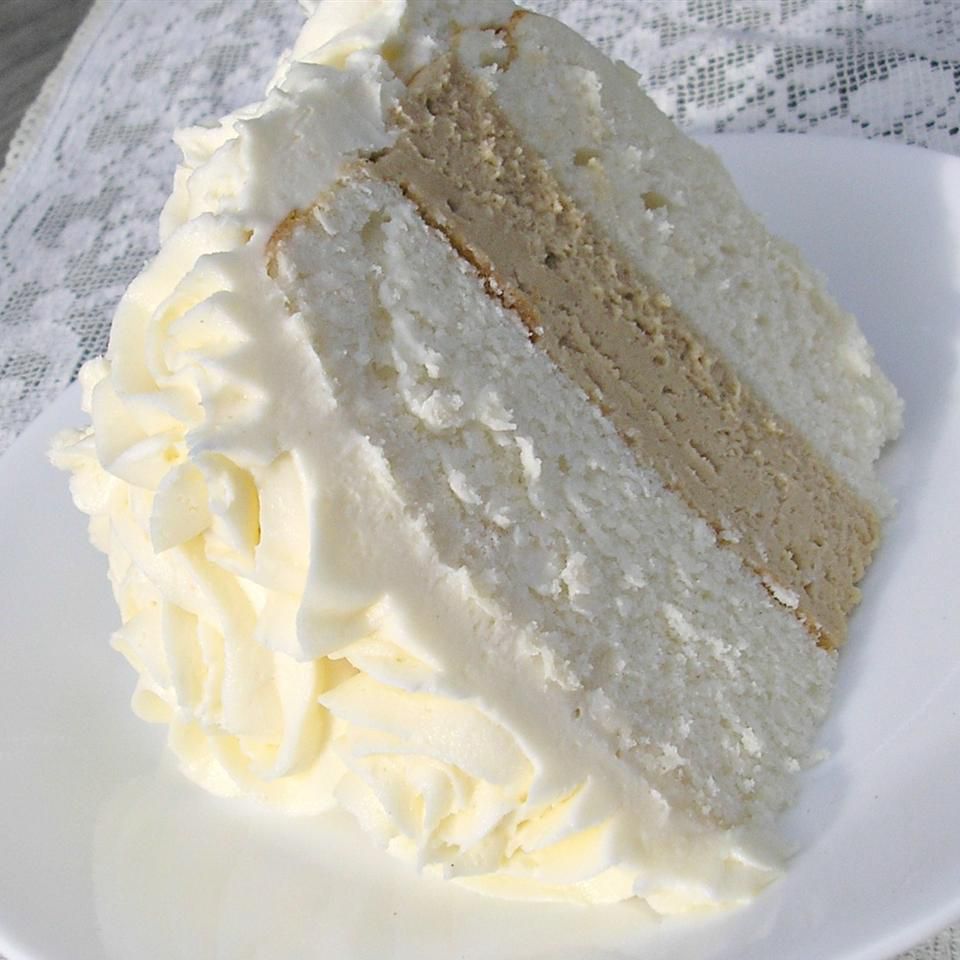 White almond wedding cake slice on white plate
