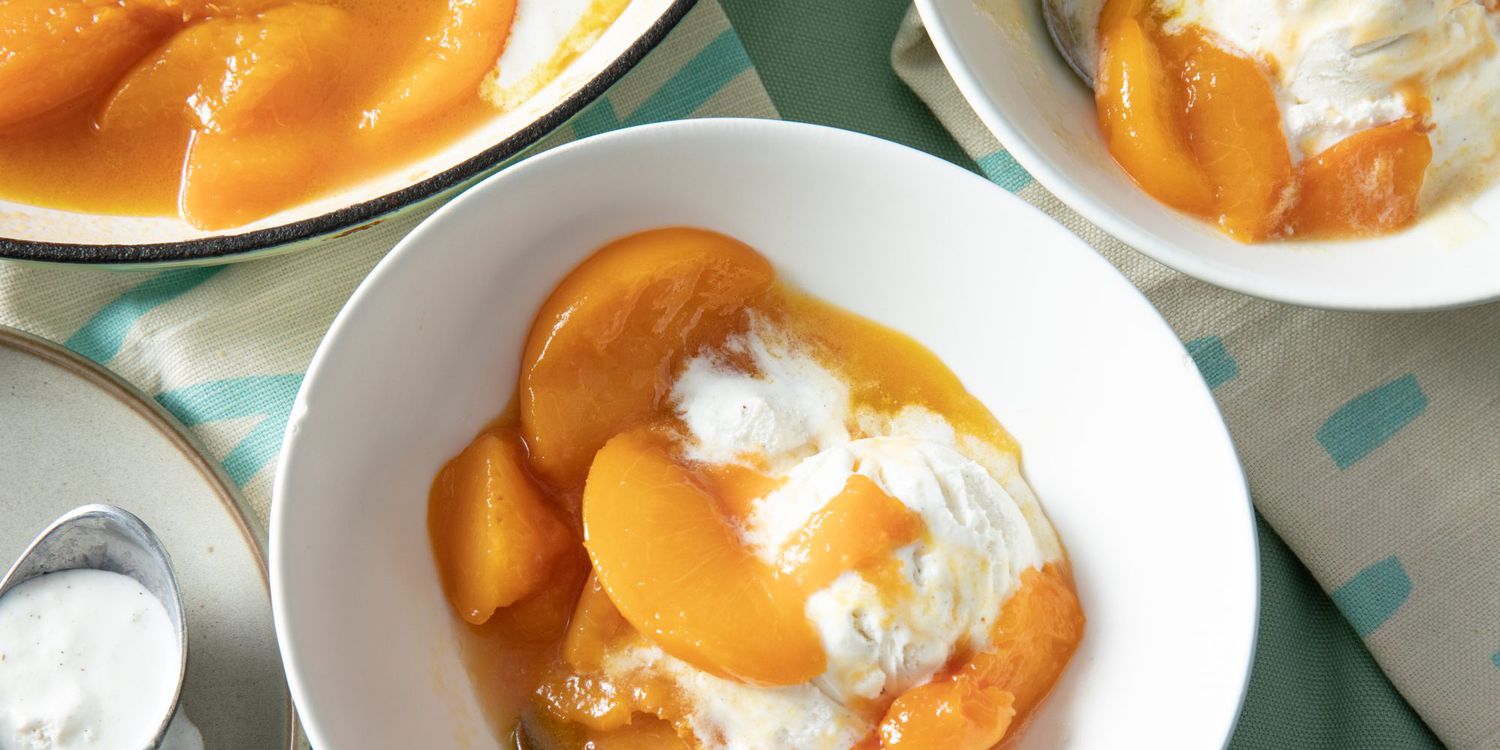 overhead on a dutch oven and two servings of tipsy peaches served with vanilla ice cream