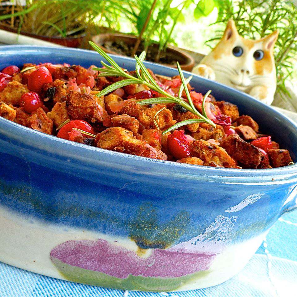 stuffing with cranberries and rosemary in blue ceramic dish