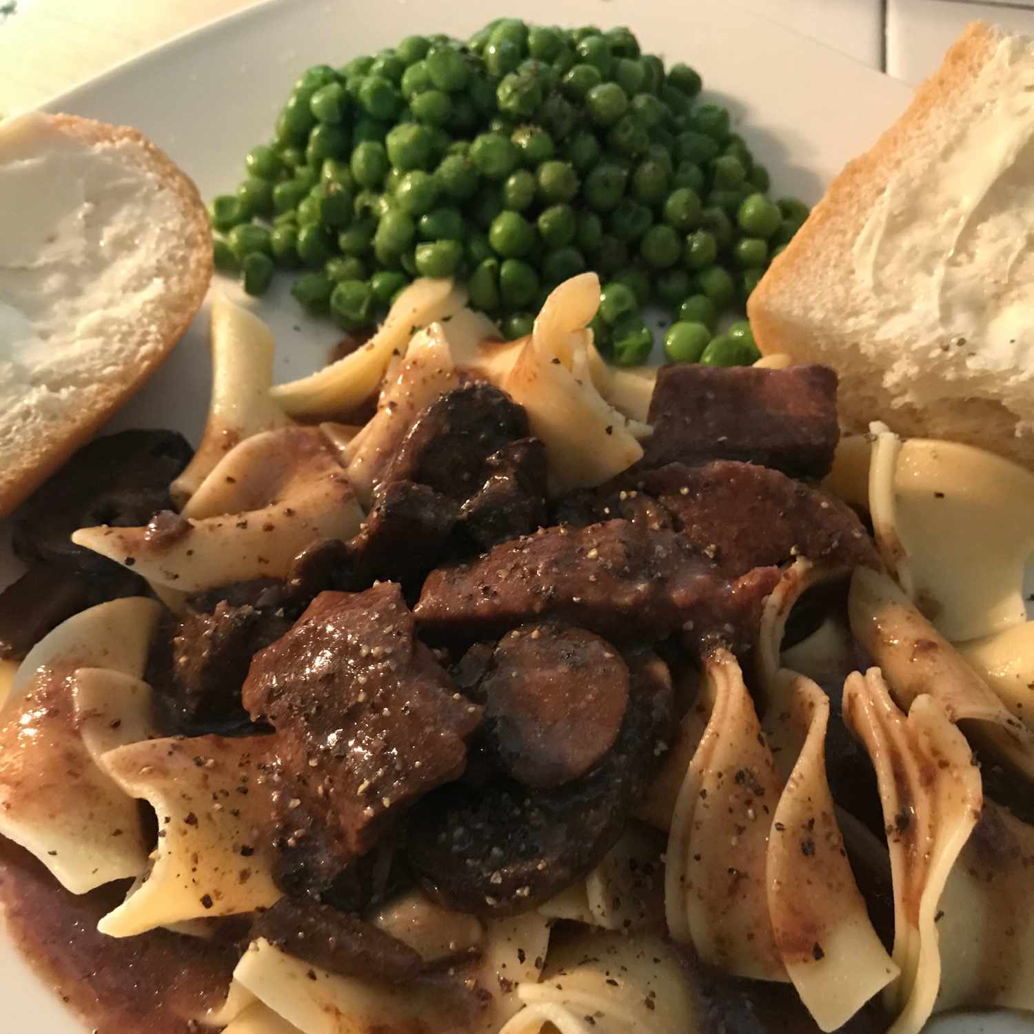 Beef Tips and Noodles on a white plate