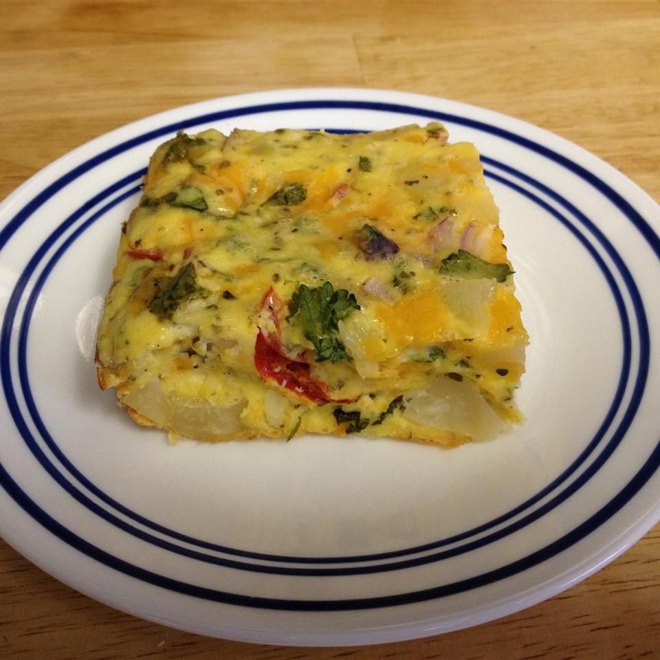 <p>This flavor-packed hash brown breakfast casserole is loaded with tomatoes, onion, cilantro, garlic, and marjoram. It's topped with shredded Cheddar cheese and baked until golden brown for a filling vegetarian breakfast. Top with your favorite hot sauce or even taco sauce for a hit of heat.</p>
                          
