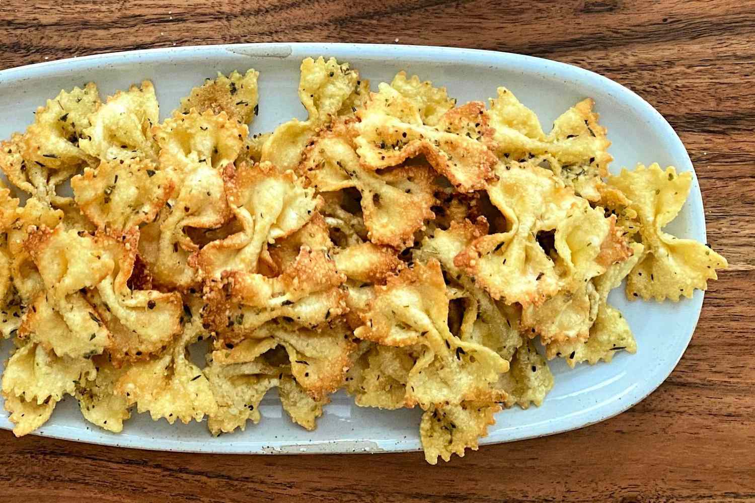 platter of air-fried farfalle pasta coated with Italian seasoning.