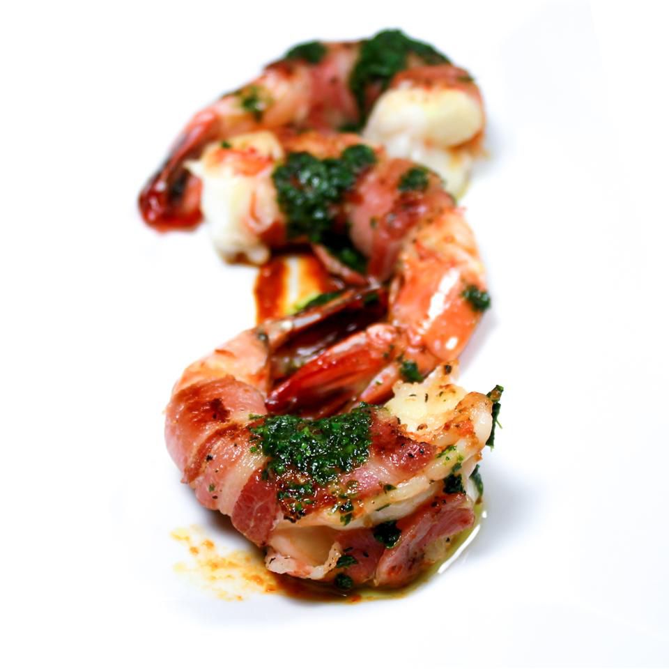 portrait shot pancetta wrapped shrimp with cilantro oil