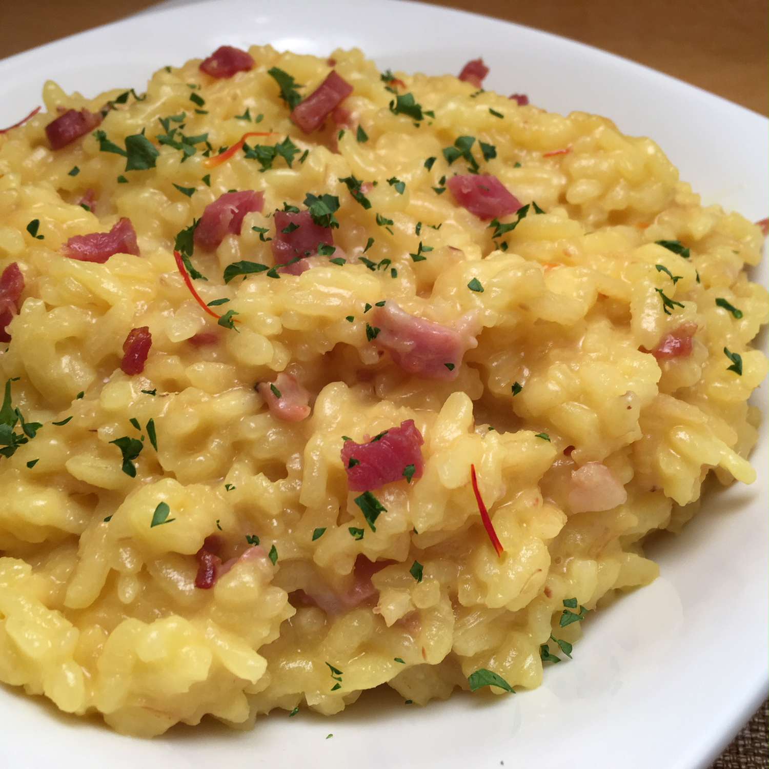 safrron risotto with pancetta and herbal garnish