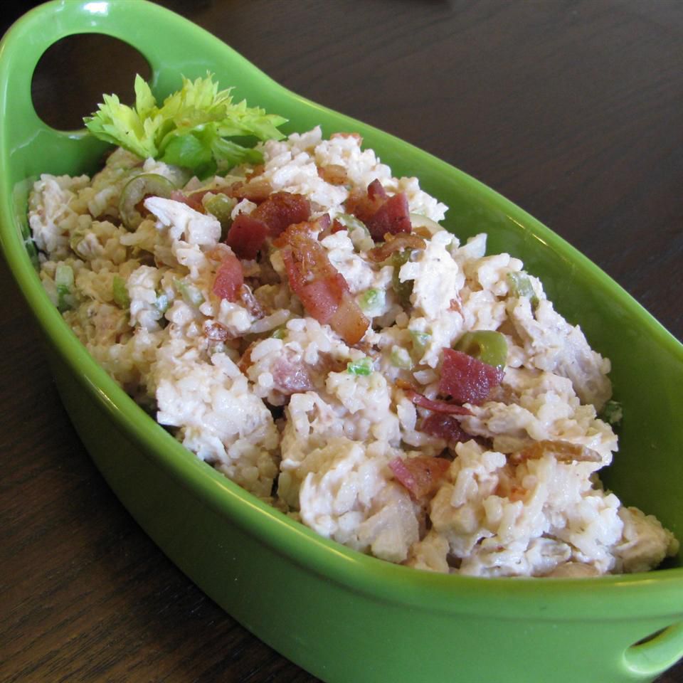 chicken salad with rice and bacon in green dish