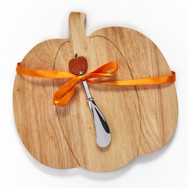 pumpkin shaped charcuterie board with stainless steel spreader with orange pumpkin tip