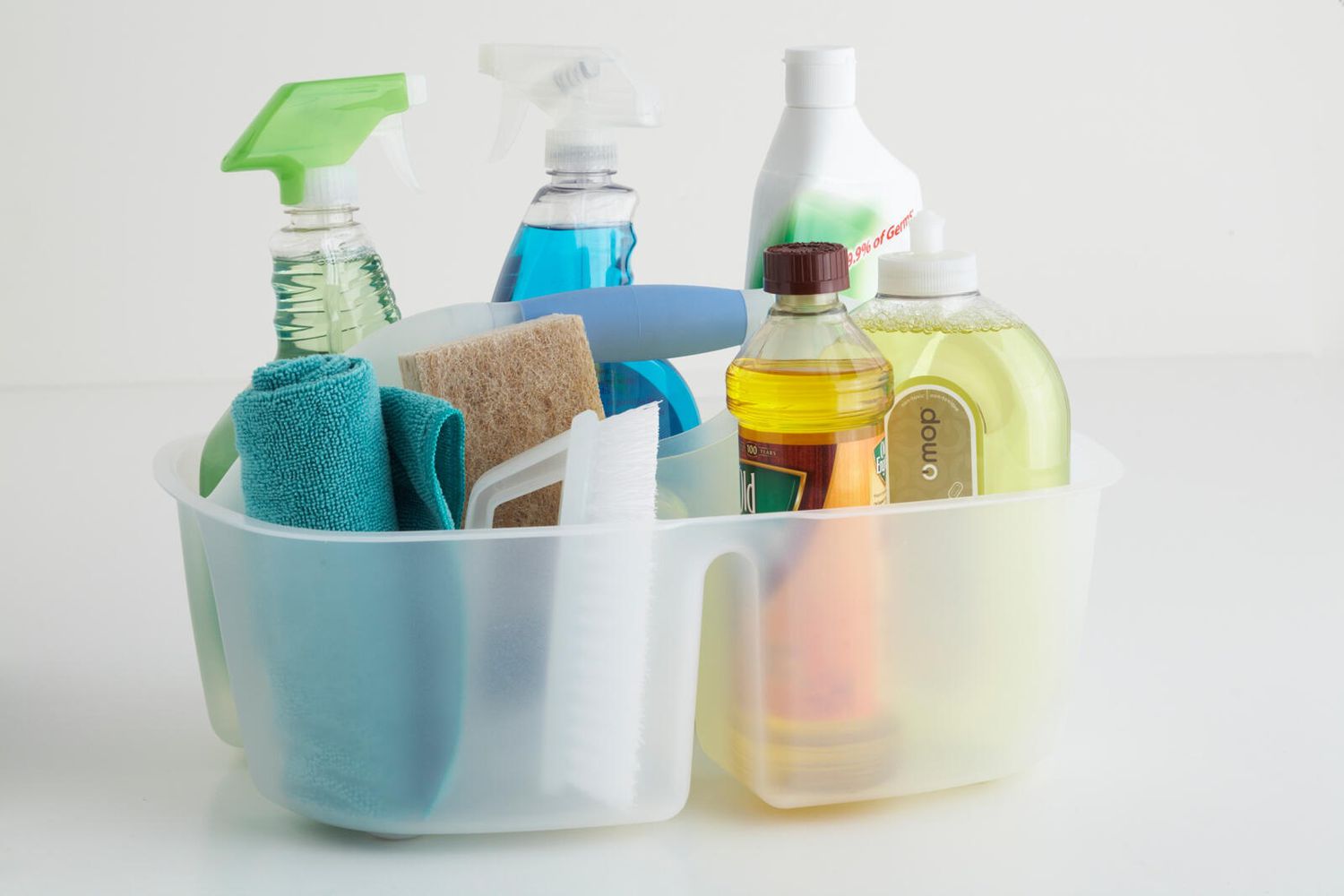 variety of cleaning products in a plastic caddy