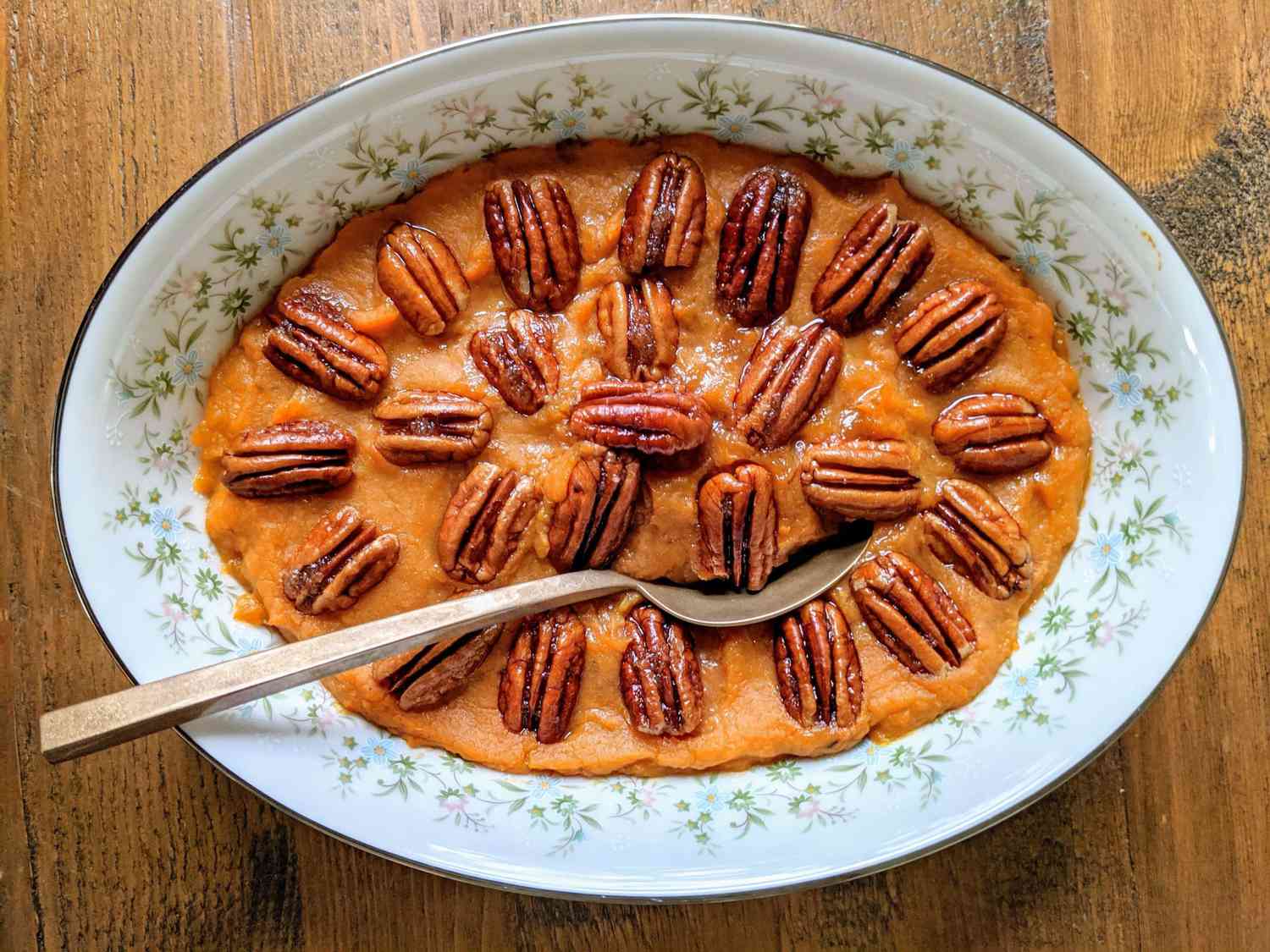 overhead view of Vegan Sweet Potato Casserole recipe with a decorative pattern of pecan halves on the top