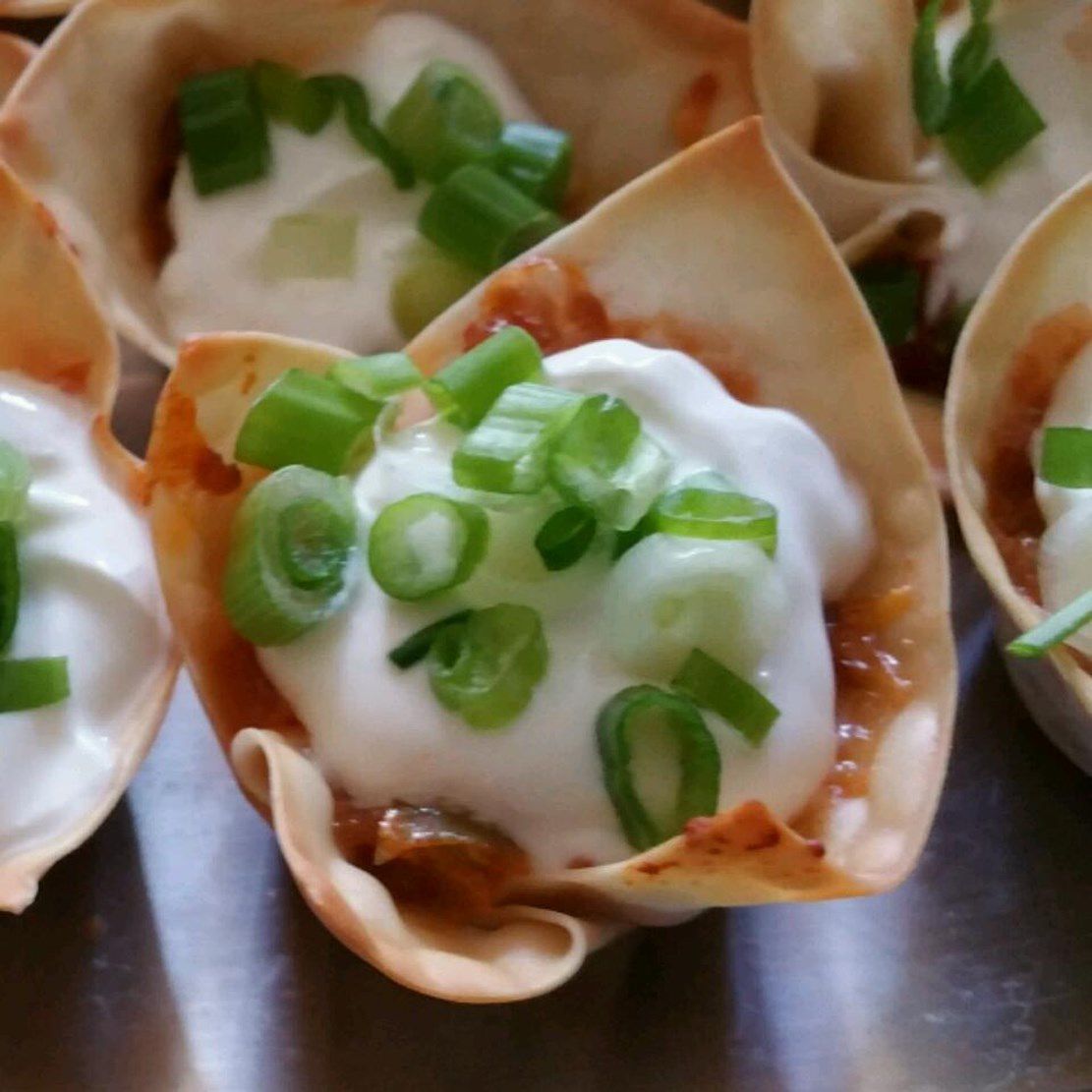 wonton cups filled with sausage and sour cream