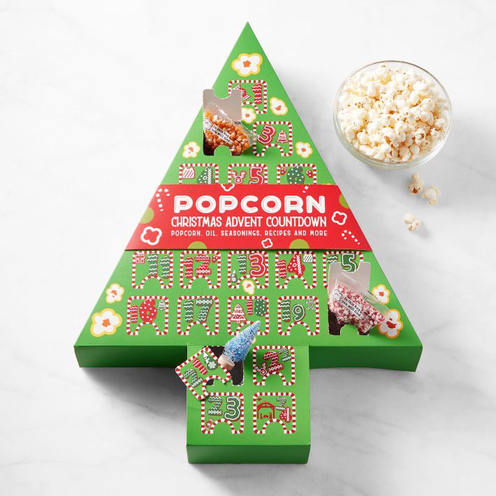 christmas tree shaped advent calendar with small bowl of popcorn