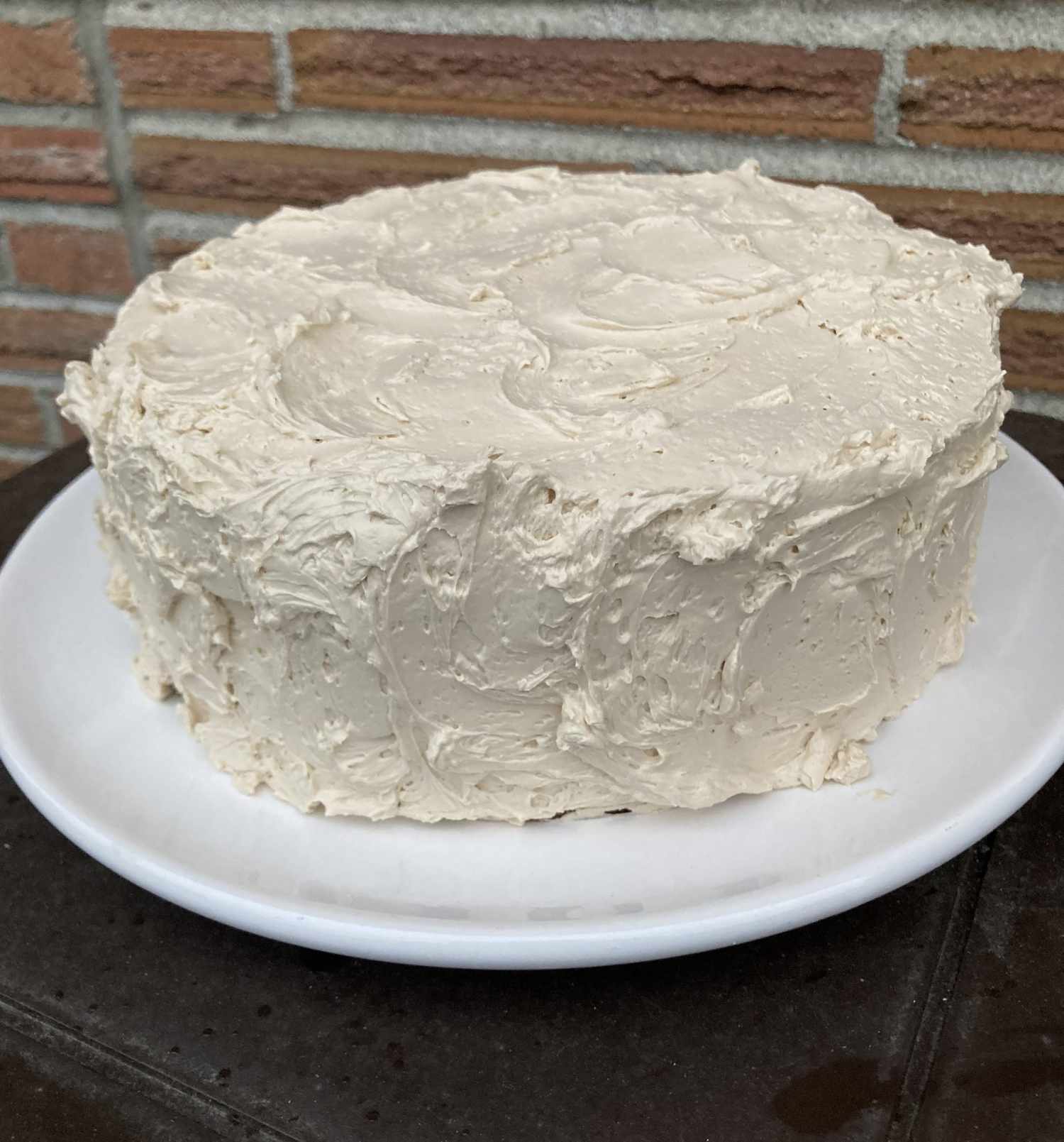 a frosted layer cake with fluffy-looking ivory colored buttercream