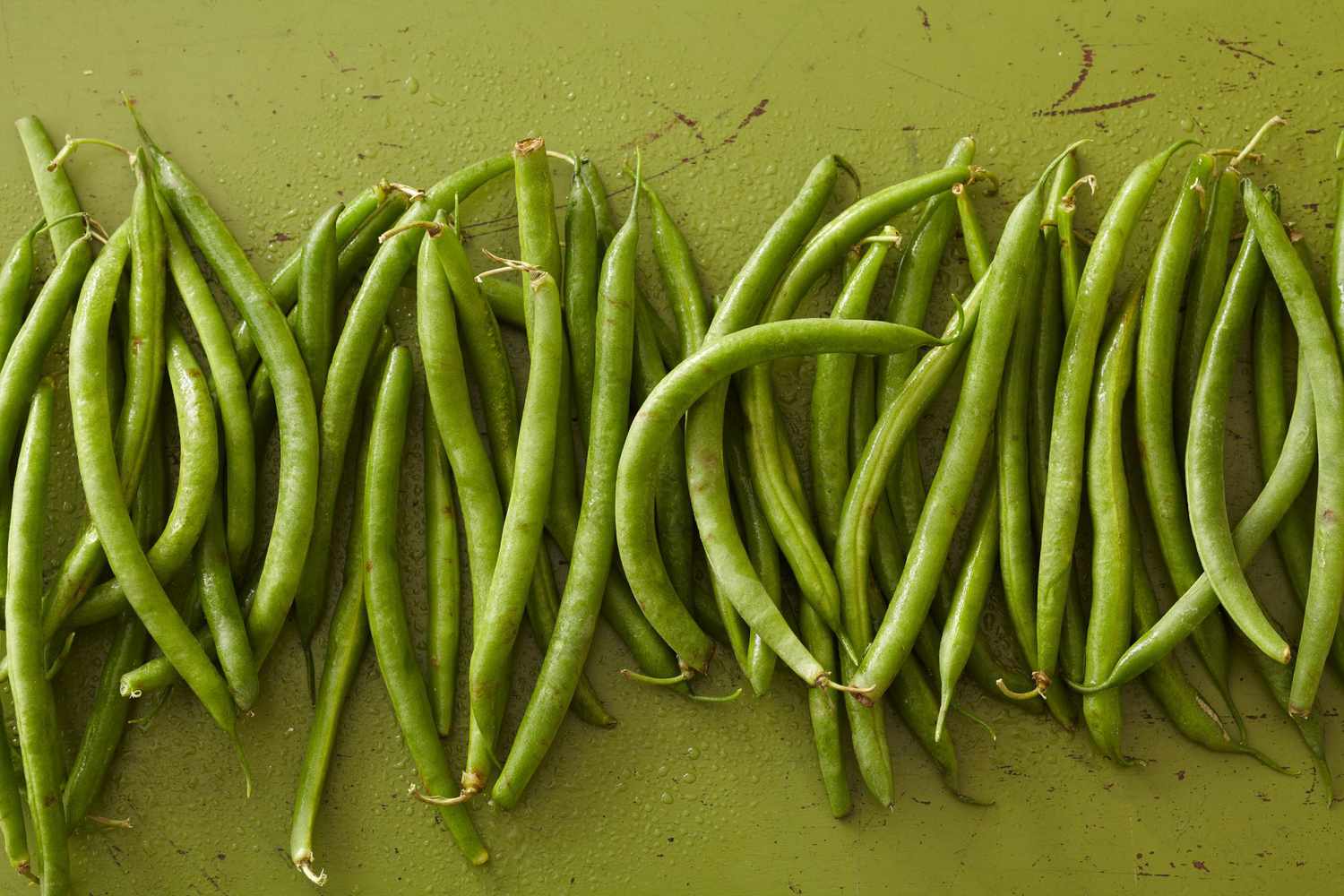 string beans on green surface