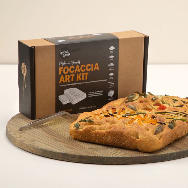 cadrboard box with decorated focaccia bread on board