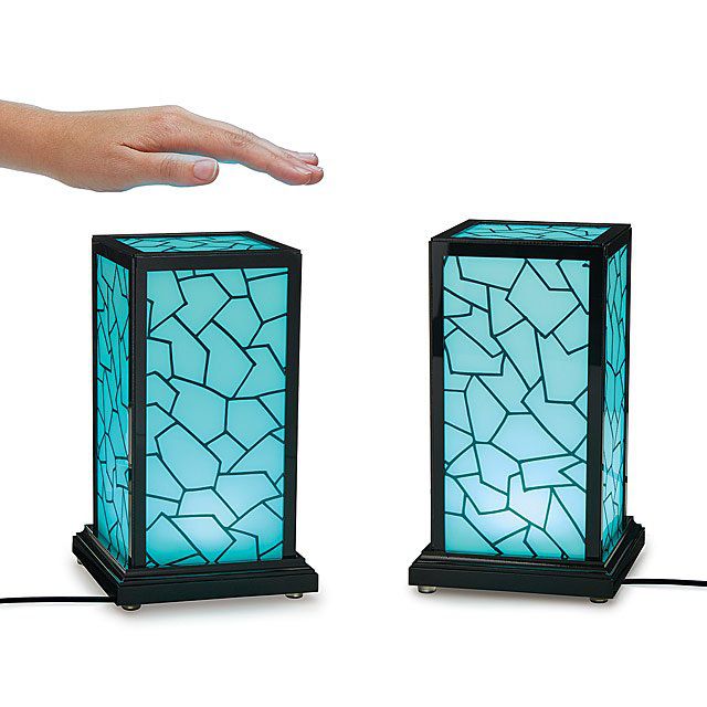 two blue light lamps with hand over one lamp