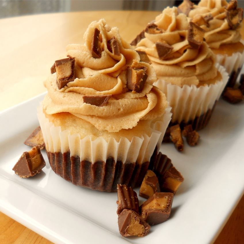 side view of Brownie Batter + Cupcake = The SECOND BEST Cupcake. Ever recipe topped with peanut butter frosting and chopped peanut butter cups