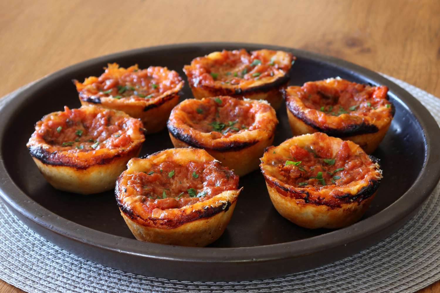 pizza muffins on a round black plate