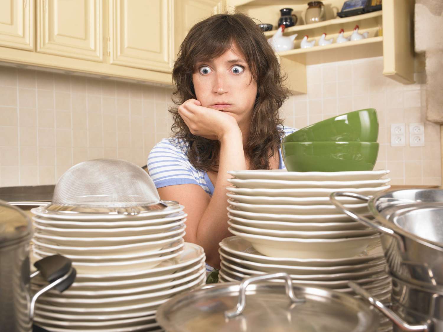 Woman with pile of plates and dishes