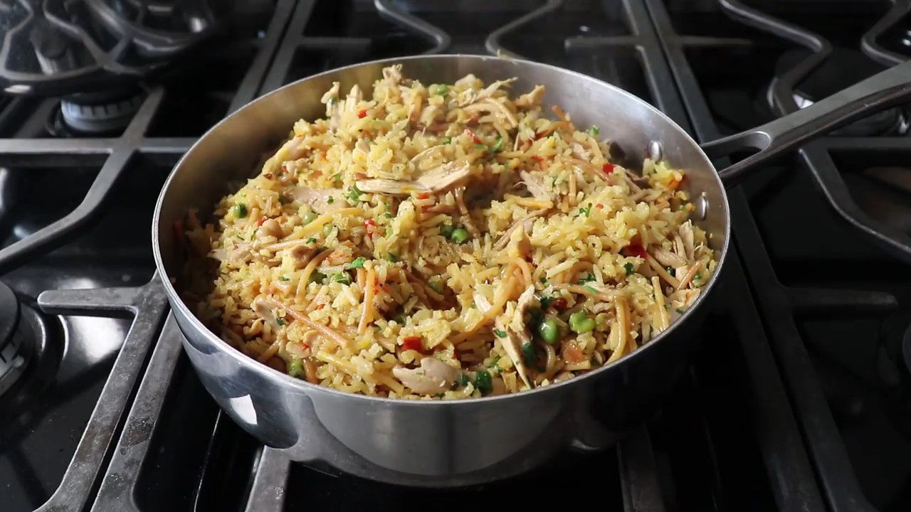 chicken, rice pilaf, and vegetables in a skillet on the stovetop