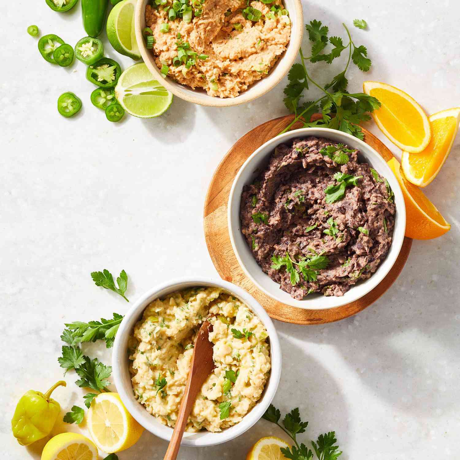 Three bowls of different bean dips