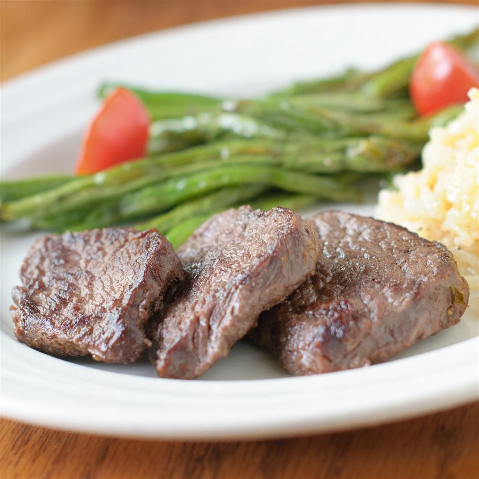 venison steaks on plate with green beans