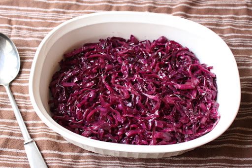 top-down view of red cabbage in a white ceramic serving dish