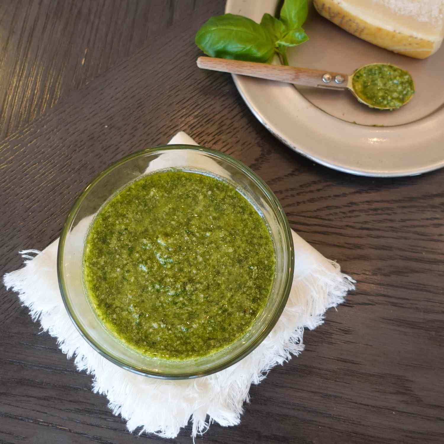 Homemade basil pesto in a clear glass bowl