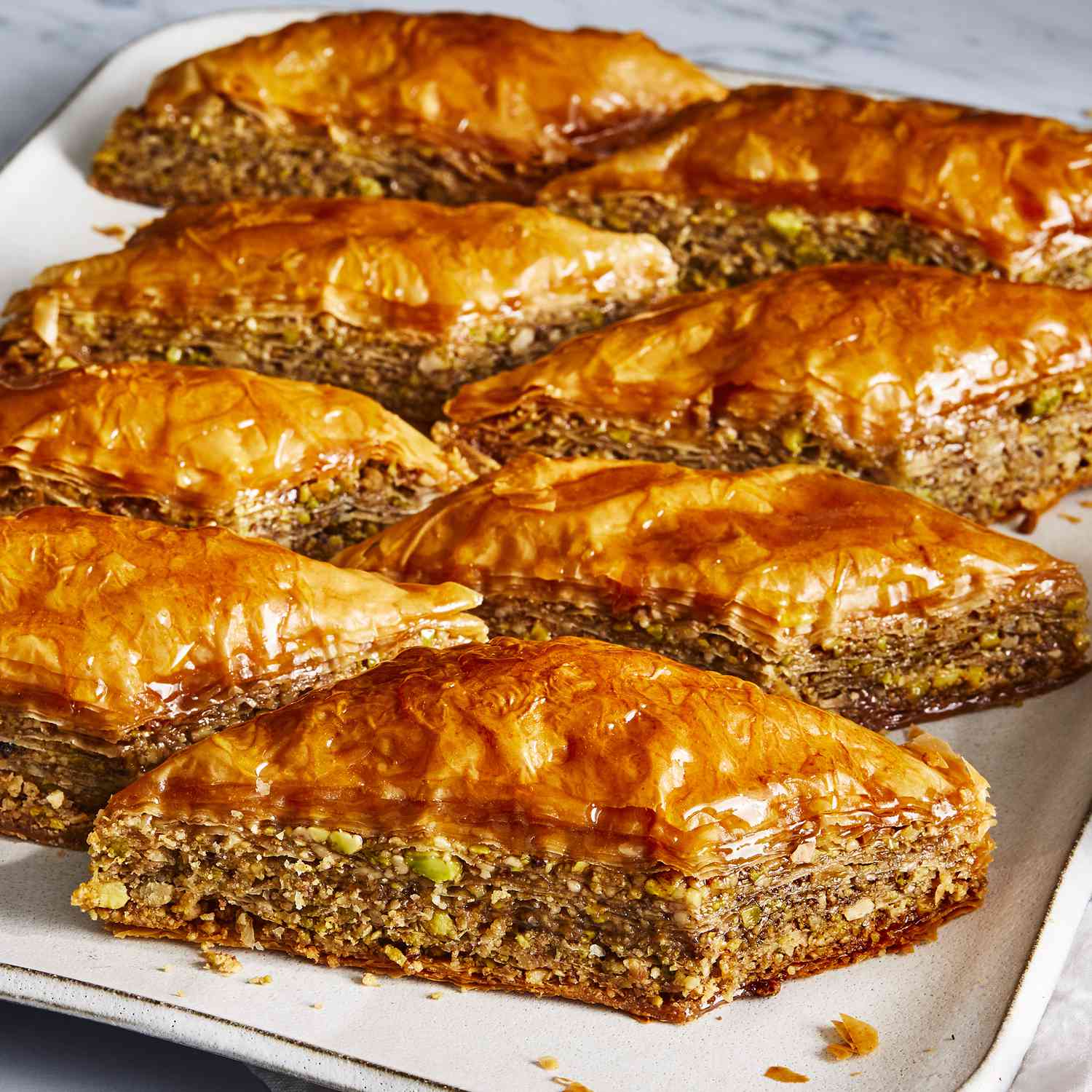 a low angle, close up view of fresh, golden-brown, flaky baklava.