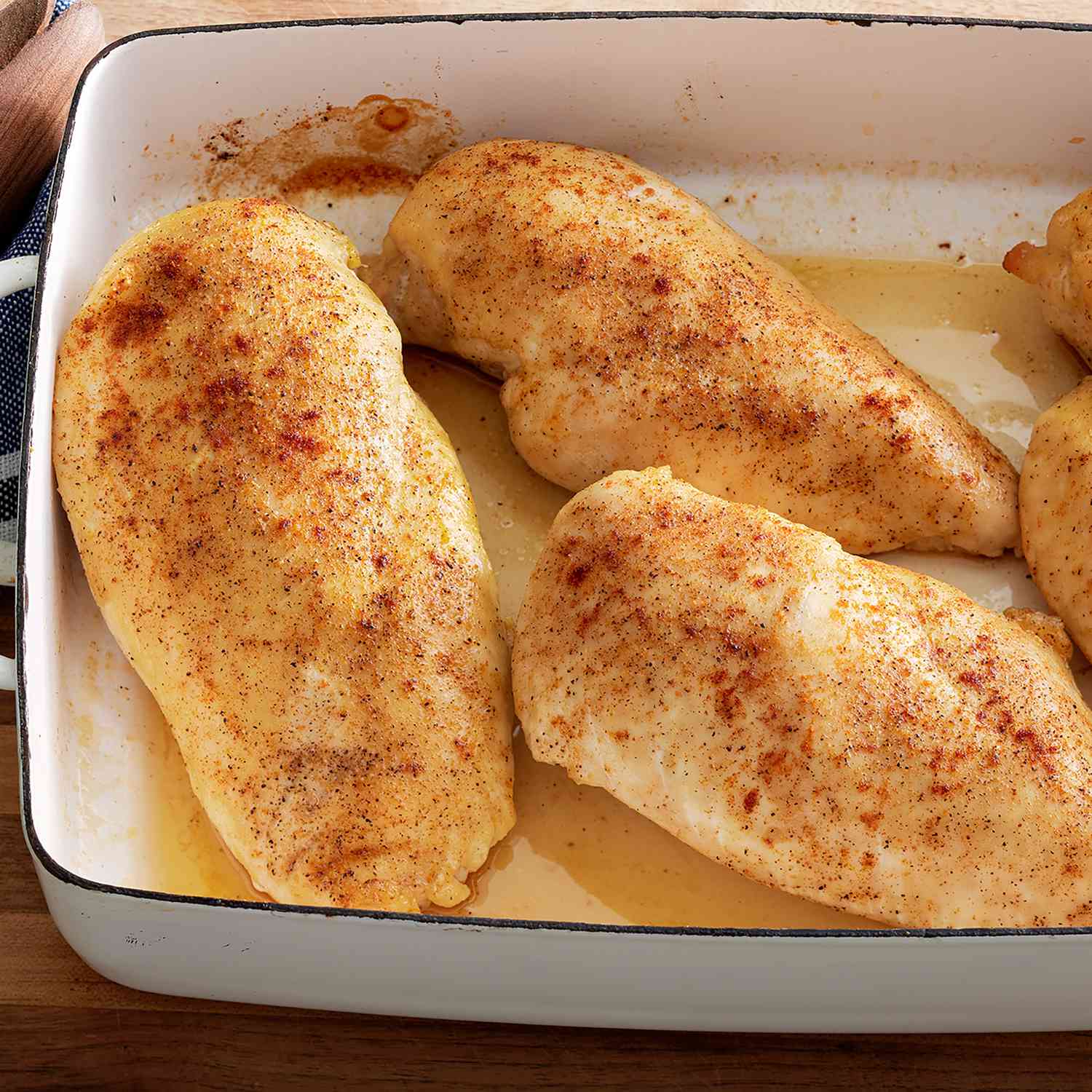 a high angle view of simple baked chicken in a white baking dish
