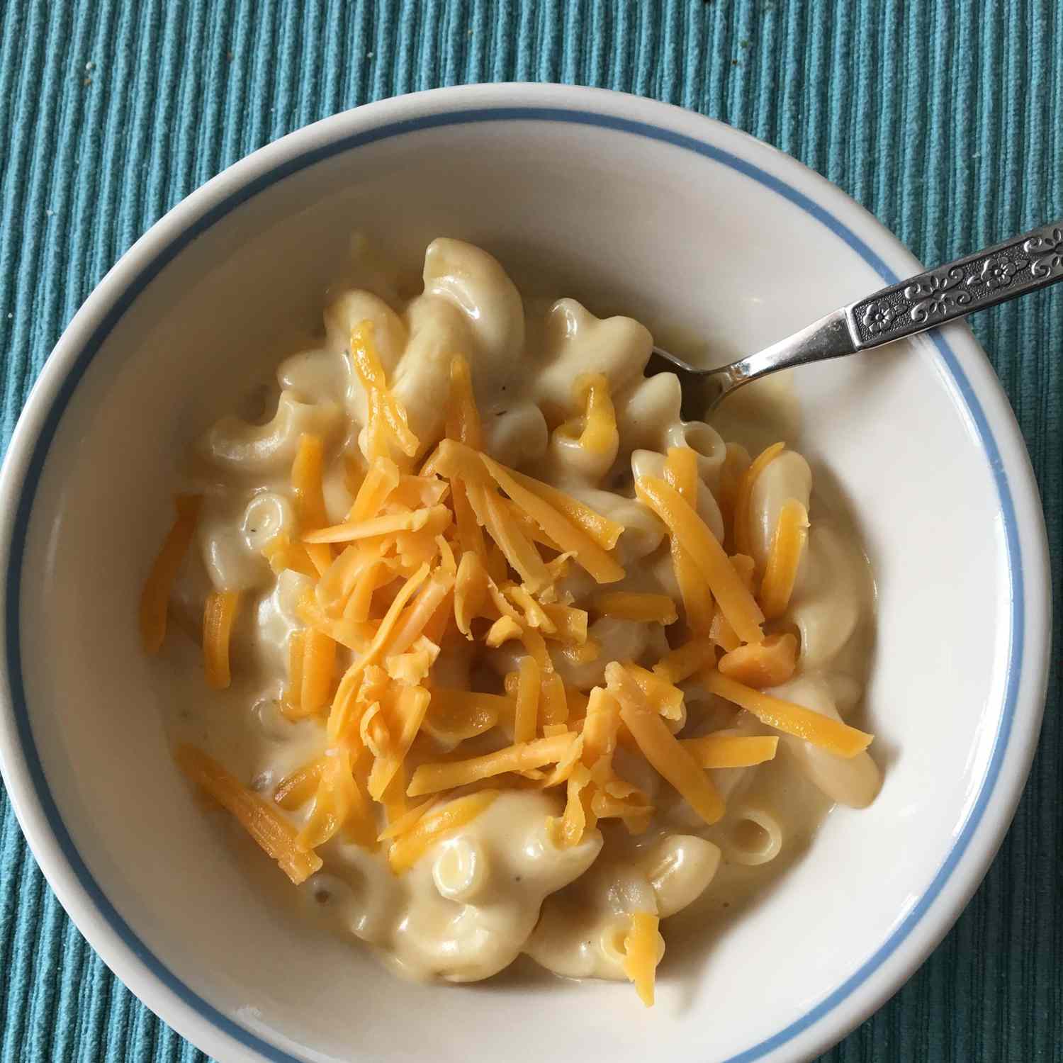 baked mac and cheese in a bowl with cheese on top