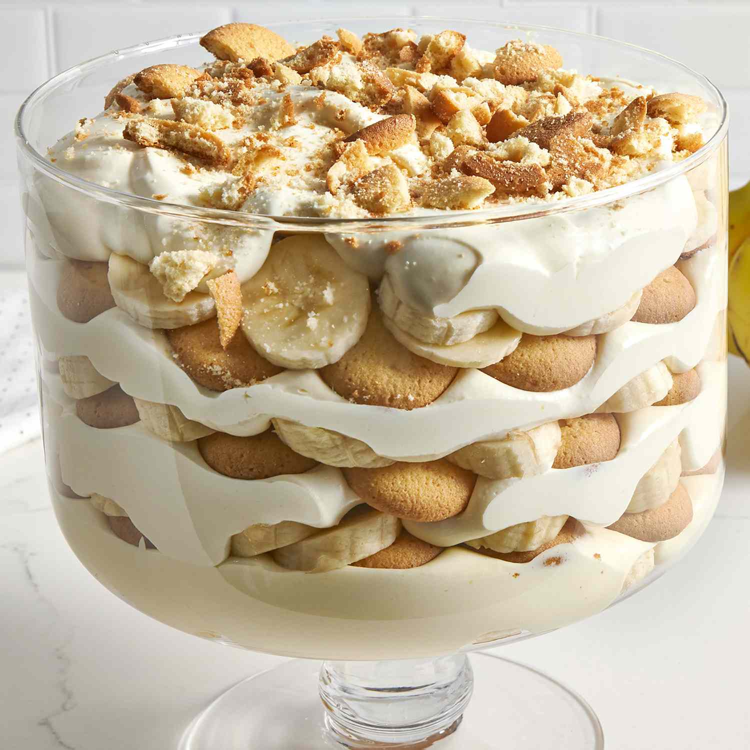a low angle view looking into the side of a trifle dish layered with the best banana pudding