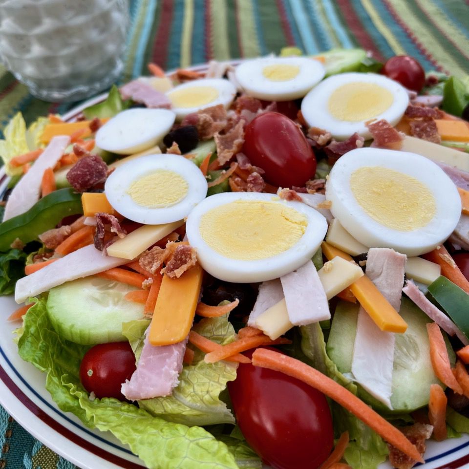 Chef salad with hard boiled eggs in bowl
