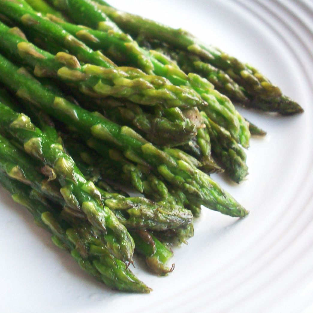 high view of pan fried asparagus served on a plate