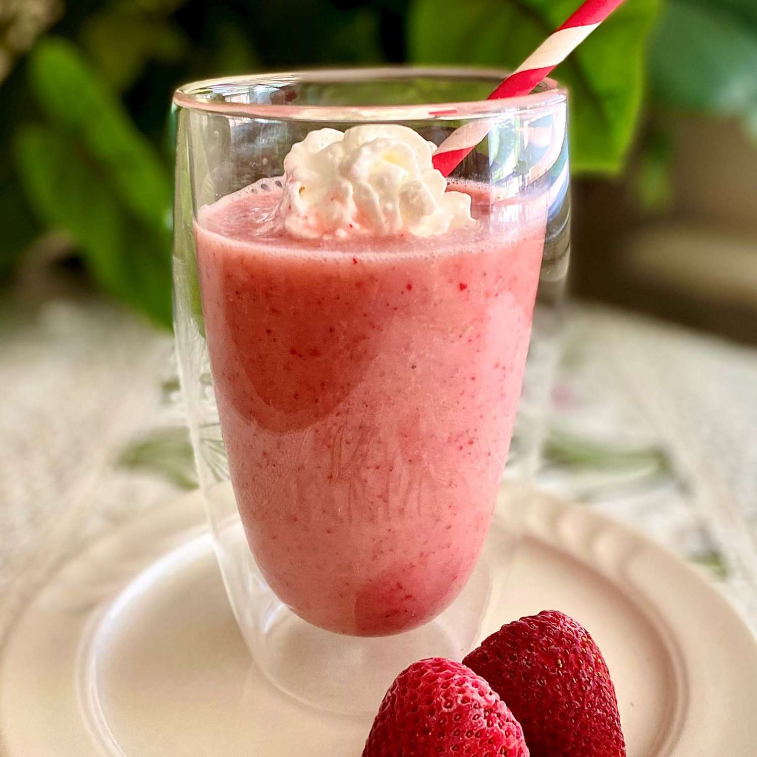 strawberry shake in glass with straw