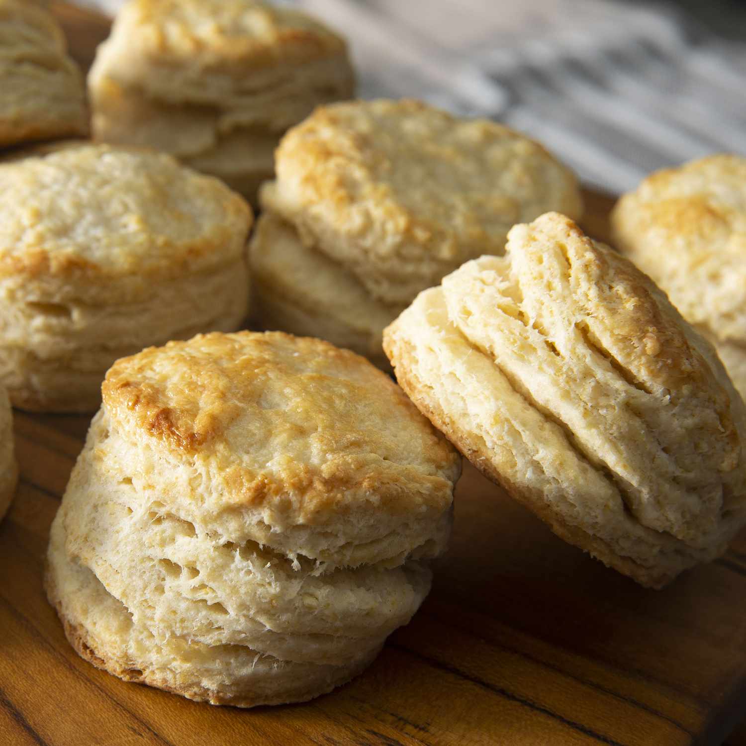 mid angle looking into a tray of many golden buttermilk biscuits