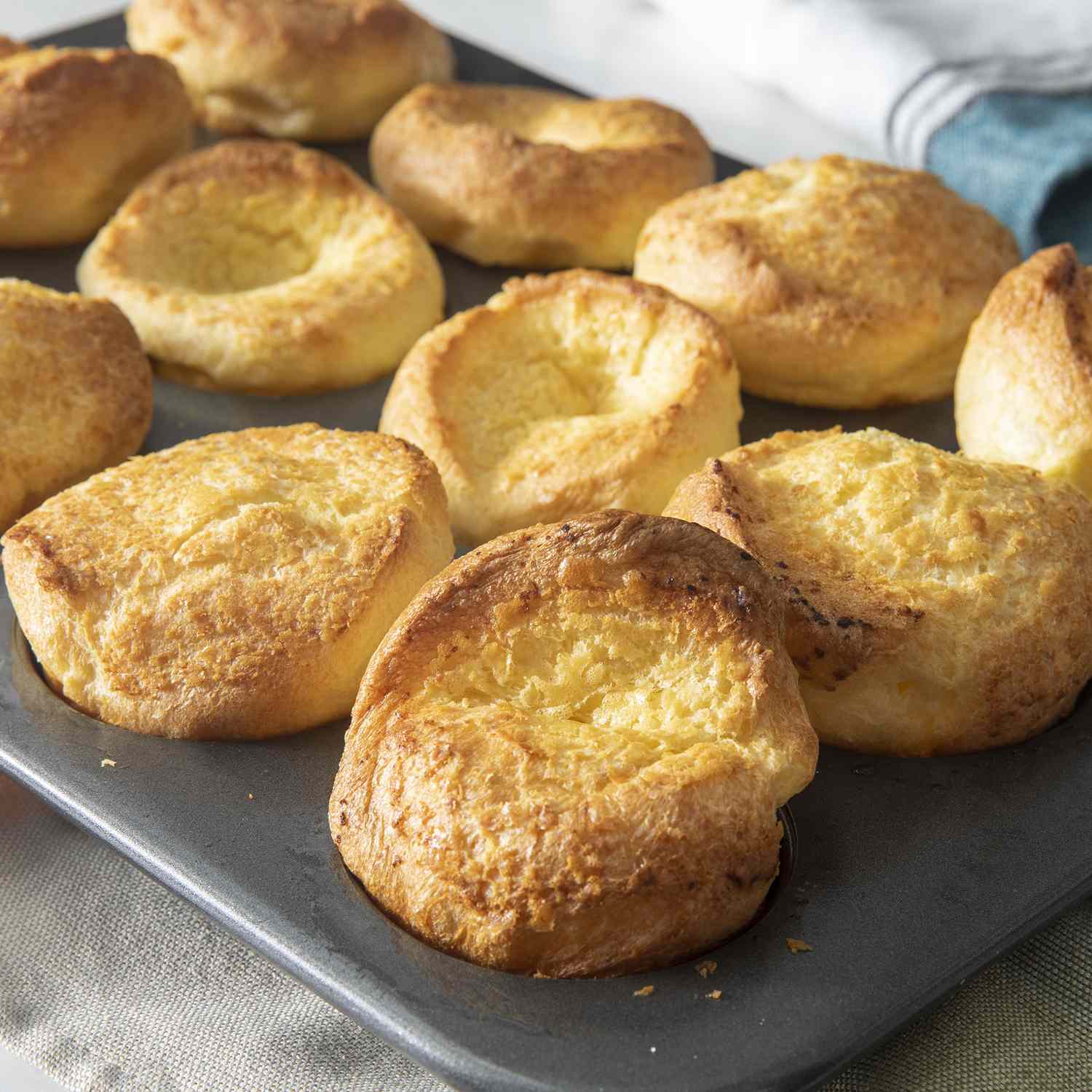 mid angle looking into multiple golden brown Yorkshire puddings served on a tray