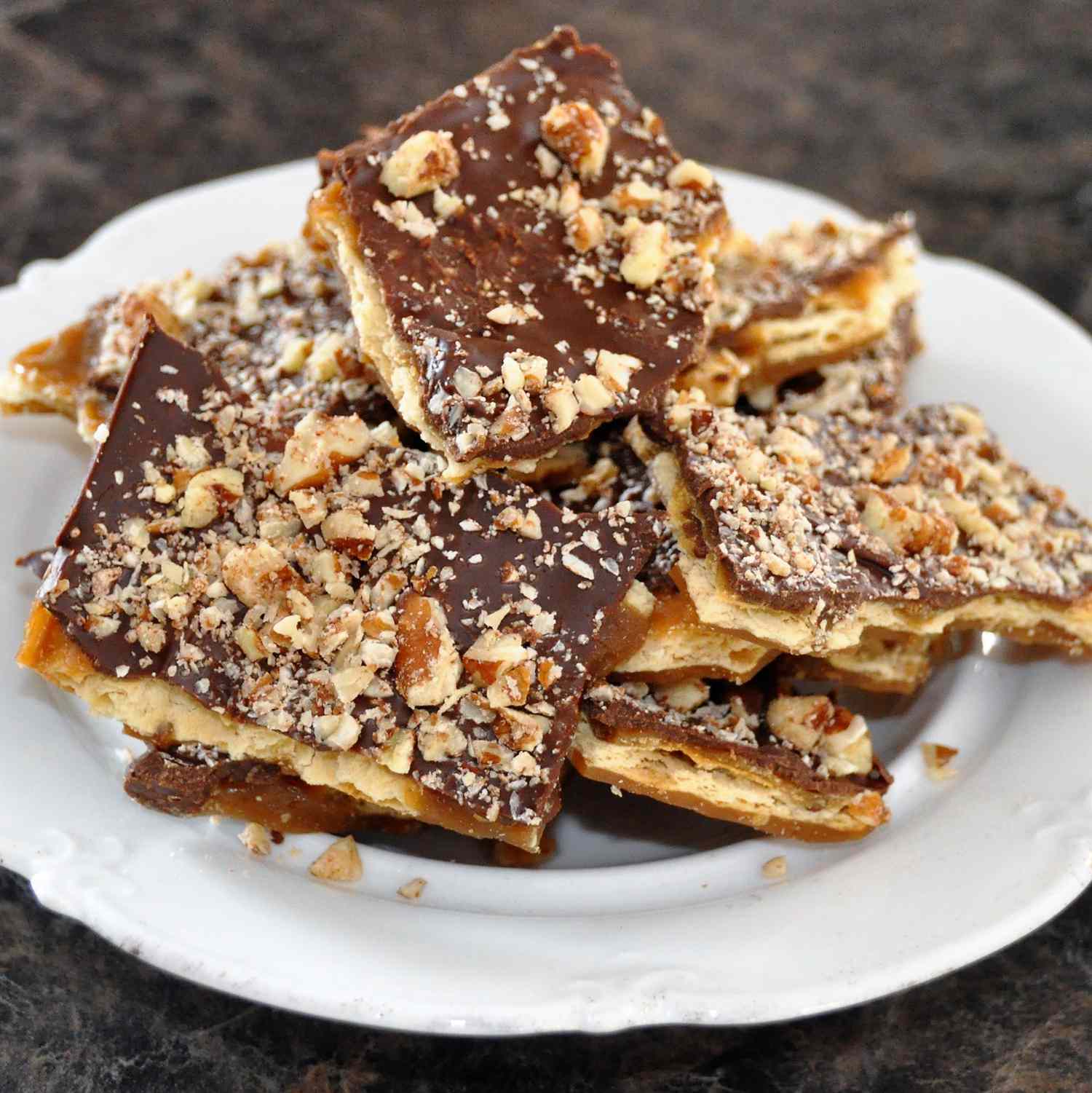 close up view of Saltine Toffee Cookies on a white plate