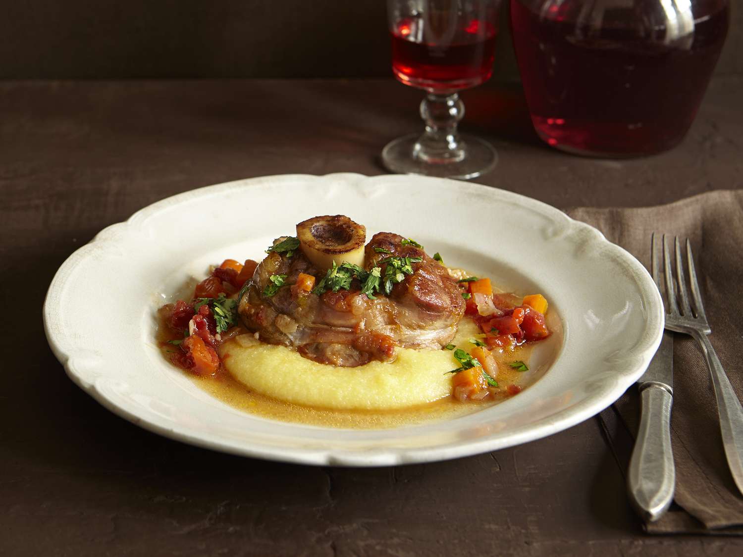 close up view of Traditional Osso Buco over polenta in a bowl