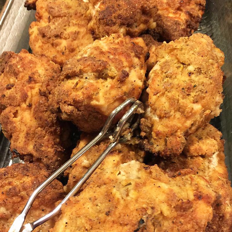 close up view of Tender Pan-Fried Chicken Breasts with tongs