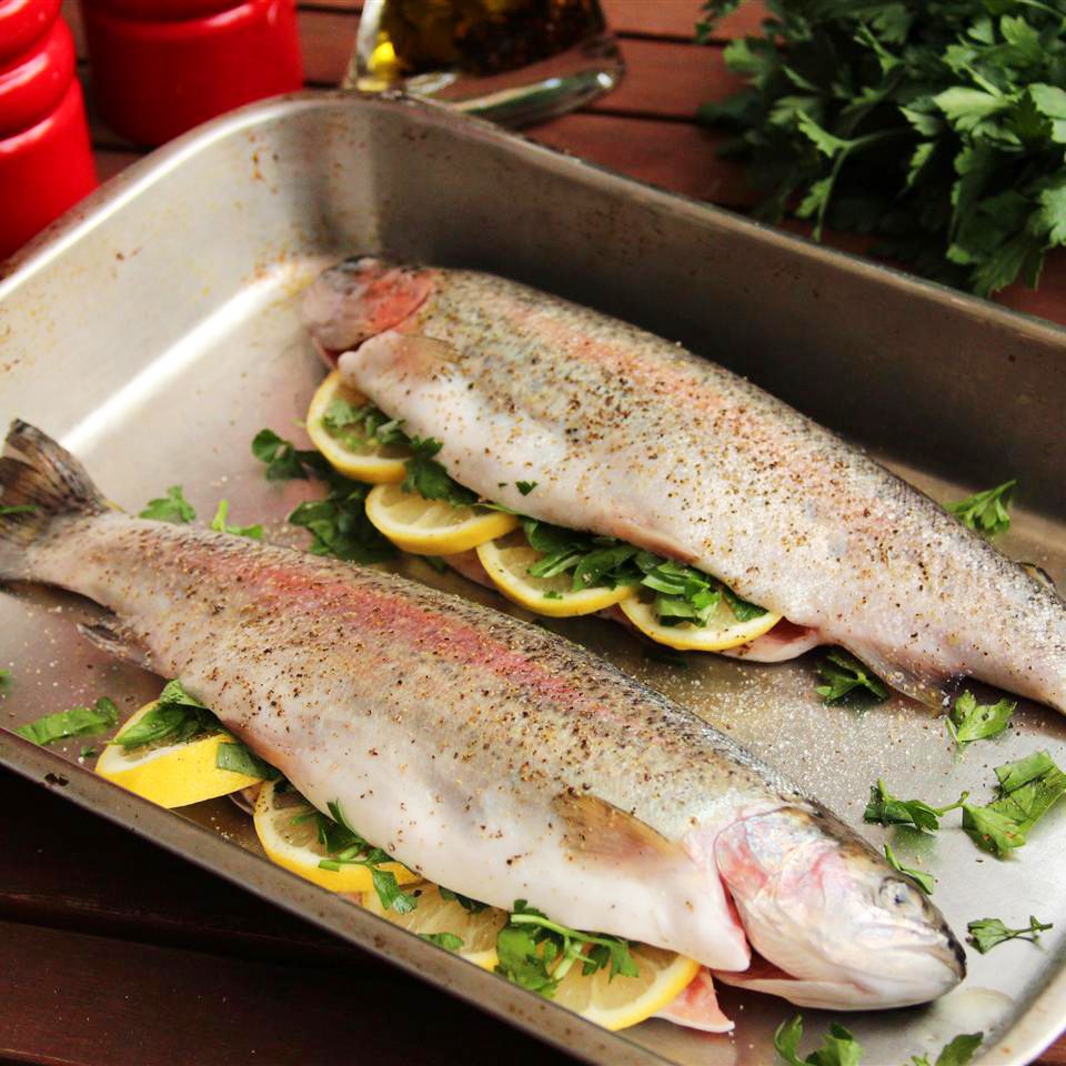 image of two Fresh Rainbow Trout stuffed with lemon and herbs in a baking dish