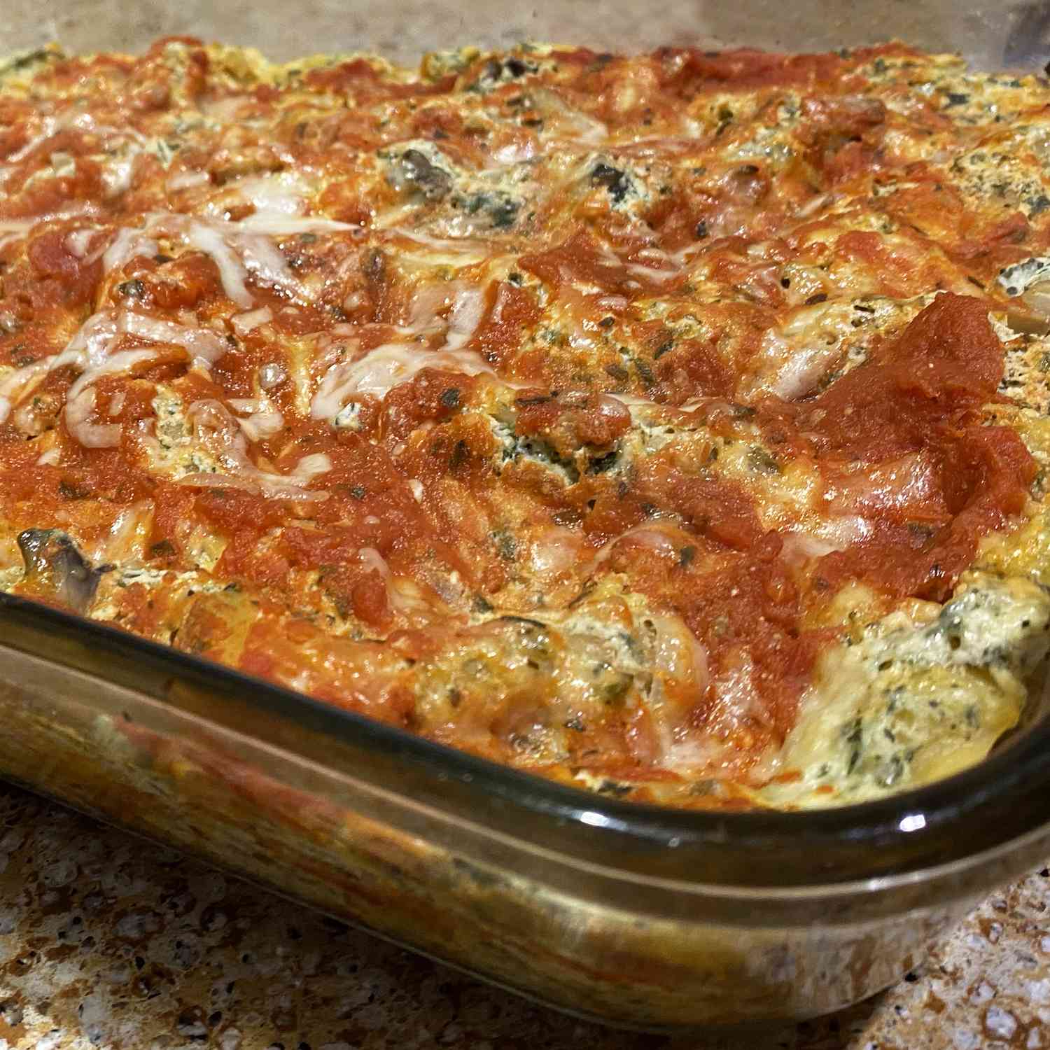 close up view of Spinach Lasagna in a glass baking dish