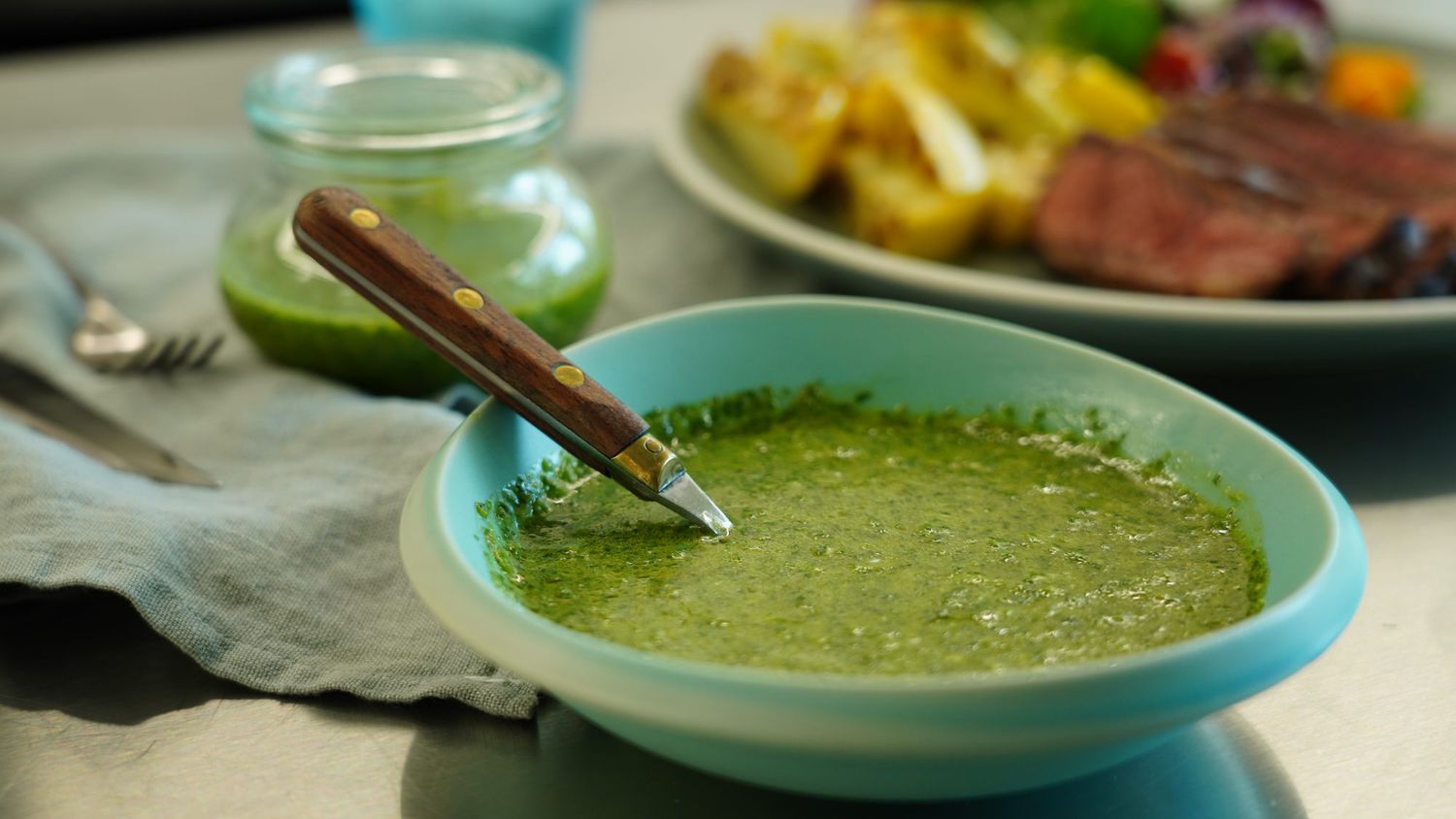 Authentic Chimichurri in a bowl with a spoon
