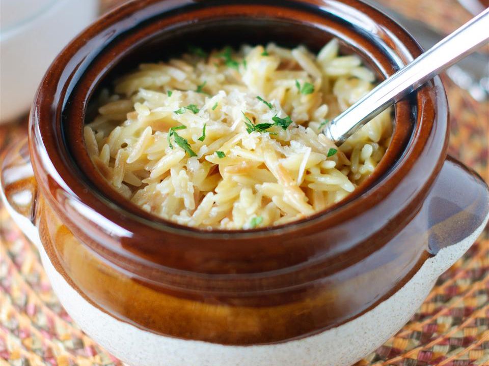 close up view of a bowl of Parmesan Garlic Orzo with a spoon