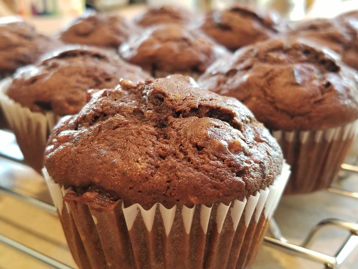close up view of Chocolate Banana Muffins on a cooling rack