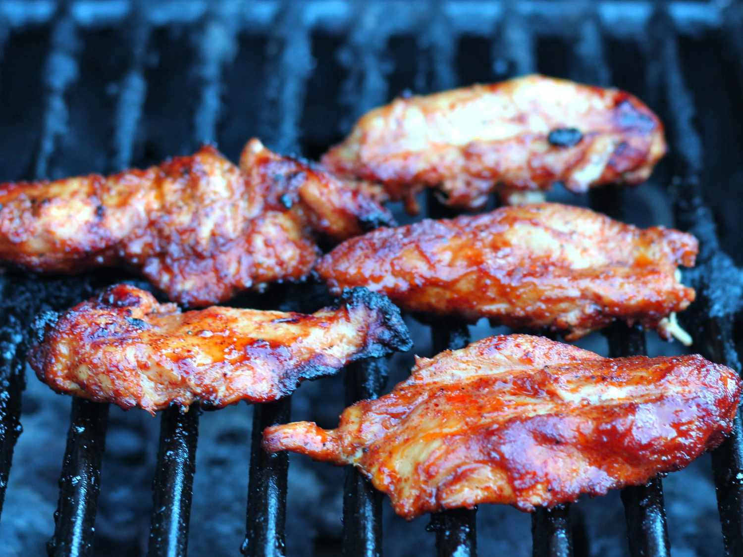close up view of chicken coated with Easy Chicken Fajita Marinade on a grill