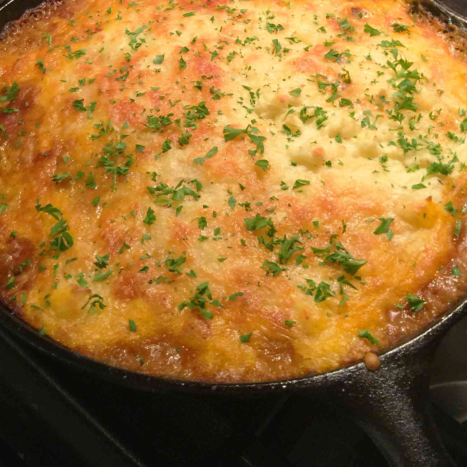 close up view of Proper English Cottage Pie in a cast iron pan