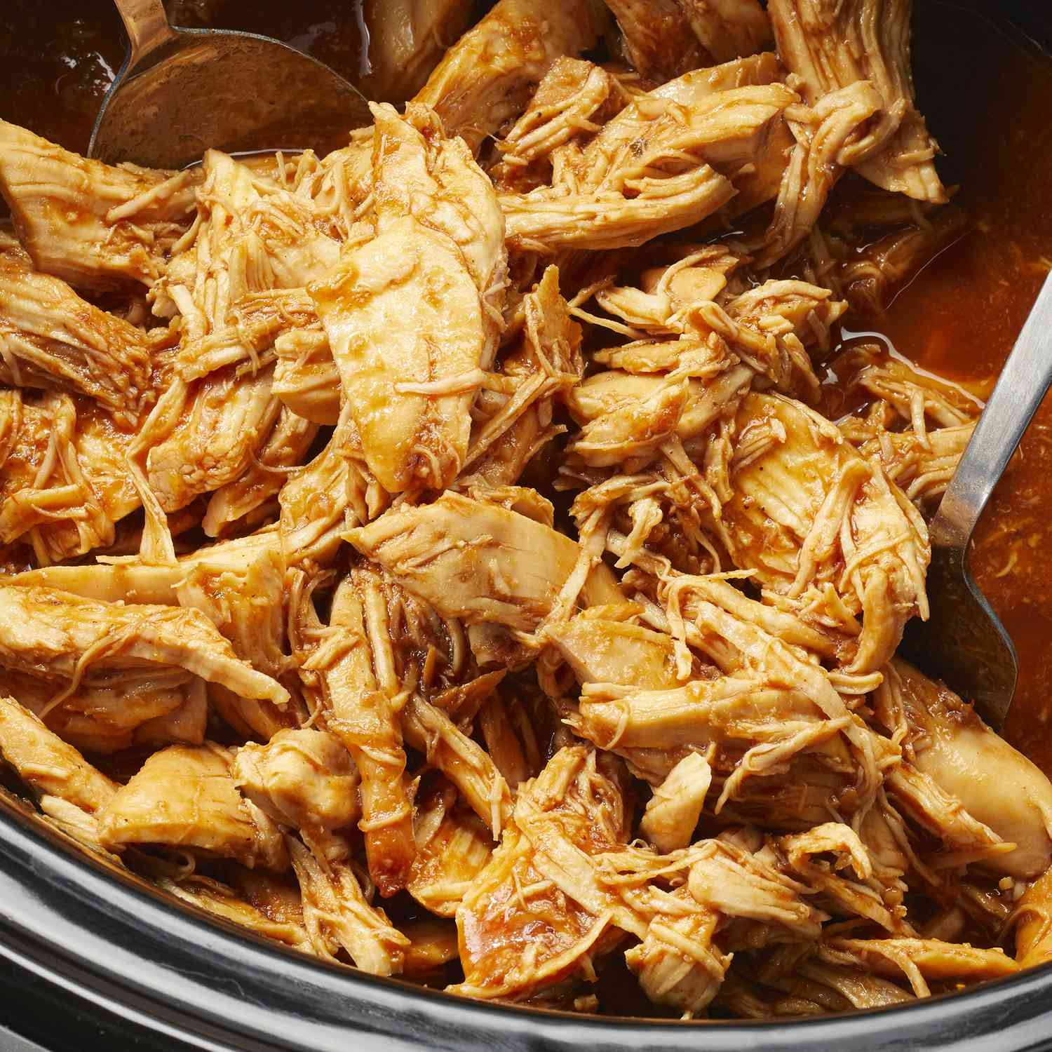 overhead angle looking down into a slow cooker of chicken barbecue