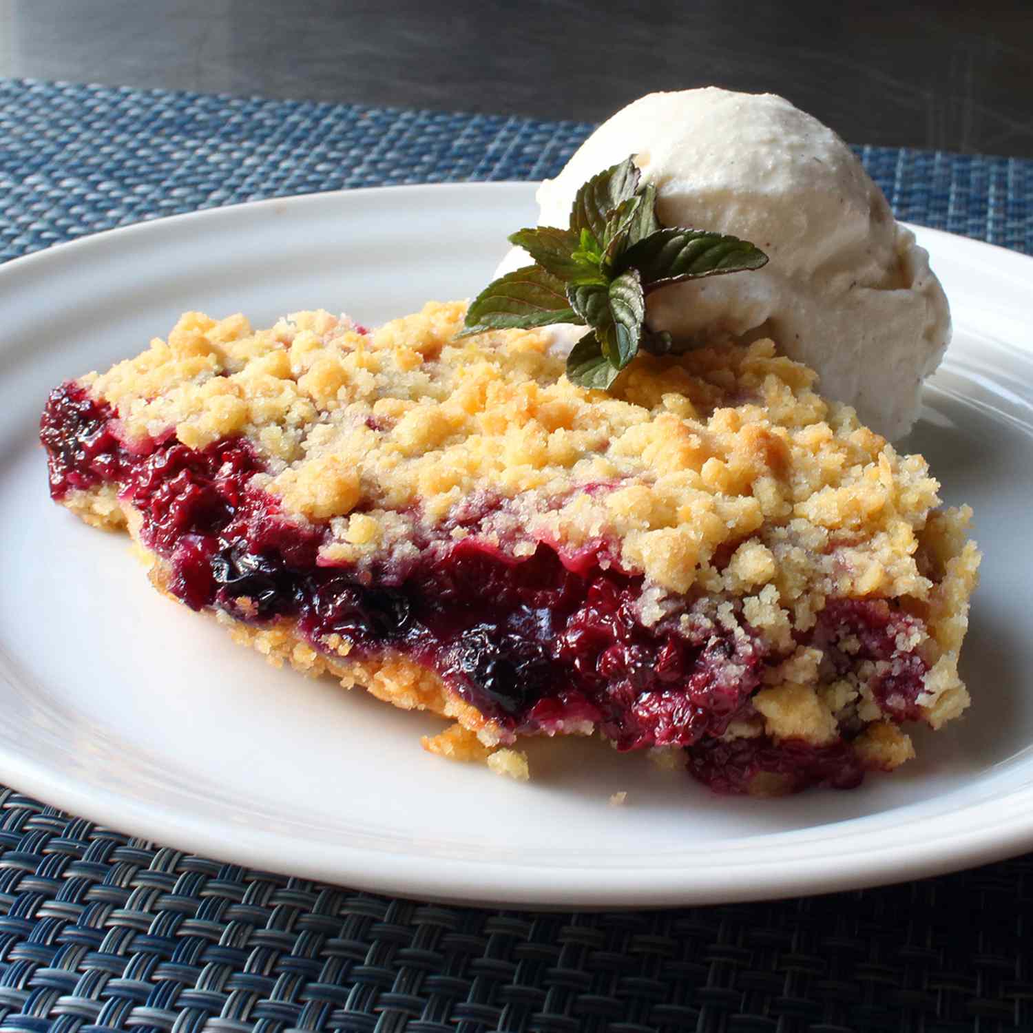 close up view of a Berry Crumble with scoop of ice cream on a plate