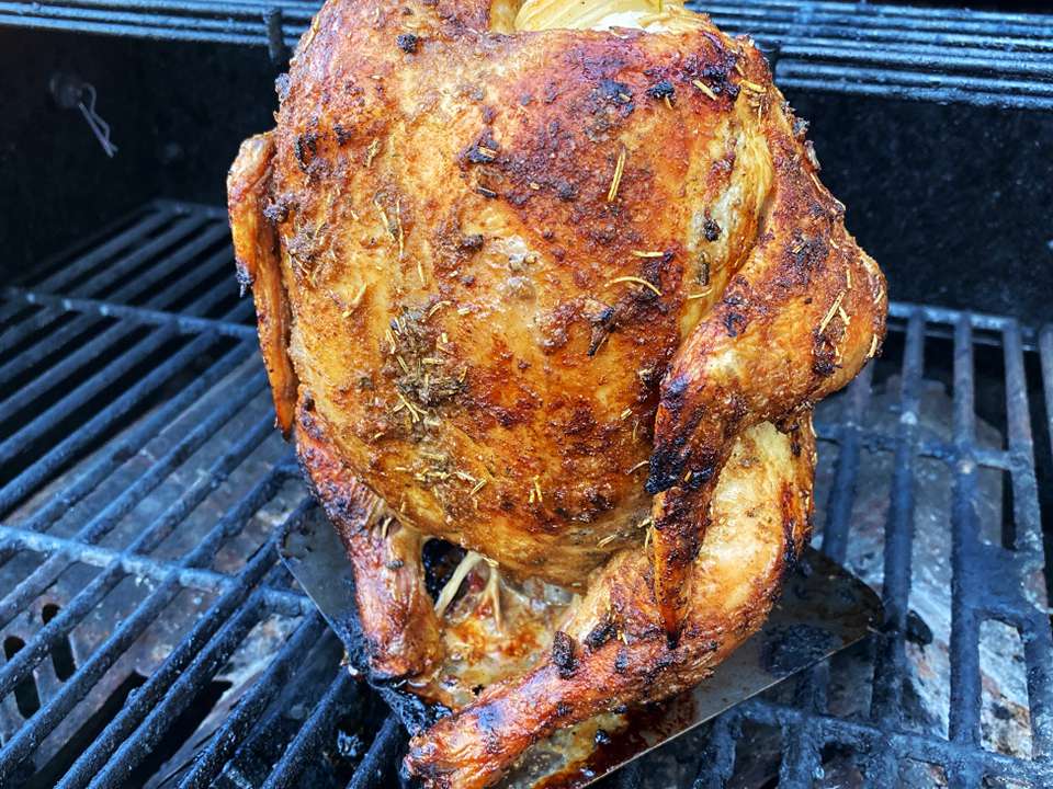 close up view of a Roasted Chicken with chicken Rub on a grill